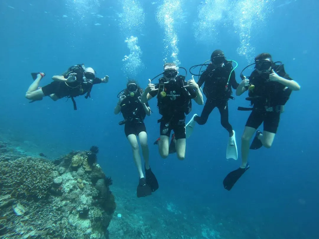 Happy PADI Open Water Divers smiling during a dive in Gili Air
